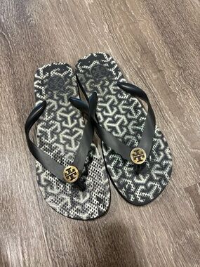 Tory Burch Black Flip Flops with Gold Logo Medallions
